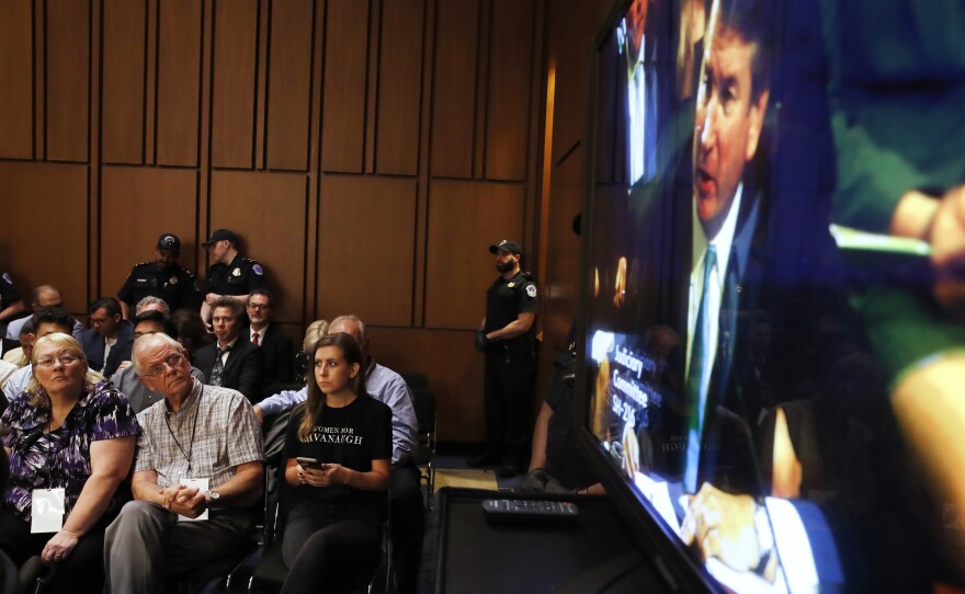 Wearing a "Women For Kavanaugh" T-shirt, Annabelle Rutledge watches with others as  Kavanaugh testifies on Wednesday.