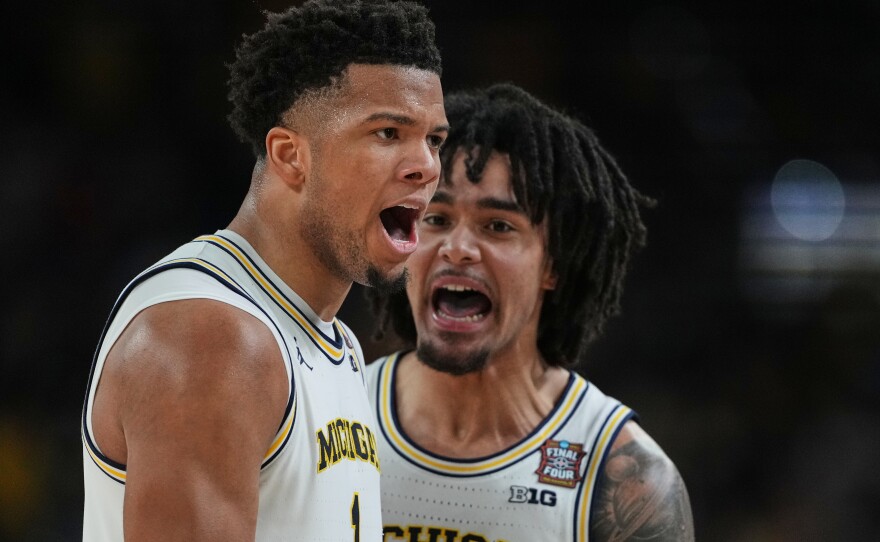 Michigan's Trey McKenney, left, and Elliot Cadeau celebrate during the second half of the NCAA college basketball tournament national championship game against UConn at the Final Four, Monday, April 6, 2026, in Indianapolis.