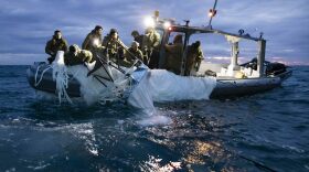 Sailors recover a high-altitude surveillance balloon in the waters off the coast of Myrtle Beach, S.C., on Feb. 5, after a fighter jet shot the balloon out of the sky.