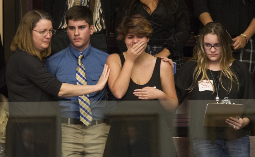 High school students from Parkland, Fla., where a young man gunned down 17 people, react as the state's House of Representatives voted not to hear a bill banning assault rifles.