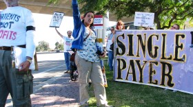 Organizer Sheila Dvorak leads protesters outside the Mission Valley offices of Blue Shield. 

