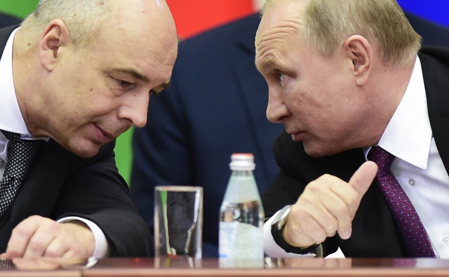 Russian President Vladimir Putin and Finance Minister Anton Siluanov chat during a meeting on Dec. 6, 2018.