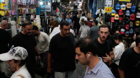 People walk in Tehran's traditional main bazaar, Iran, Saturday, Aug. 8, 2026.
