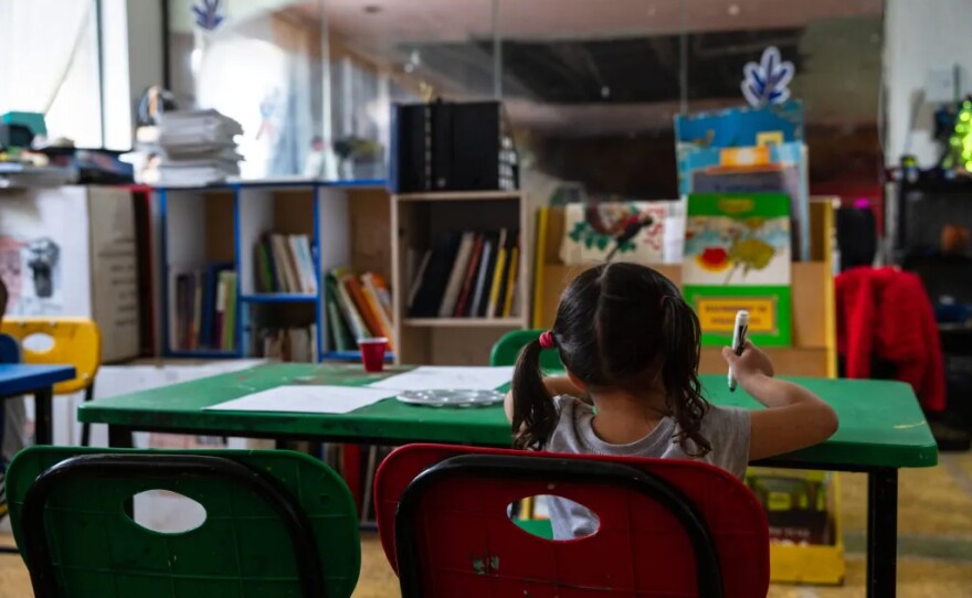 A child draws in an art class at the Border Line Crisis Center in Tijuana, Feb. 7, 2025. Some of the food used at the shelter is supplied by groups that receive American aid.