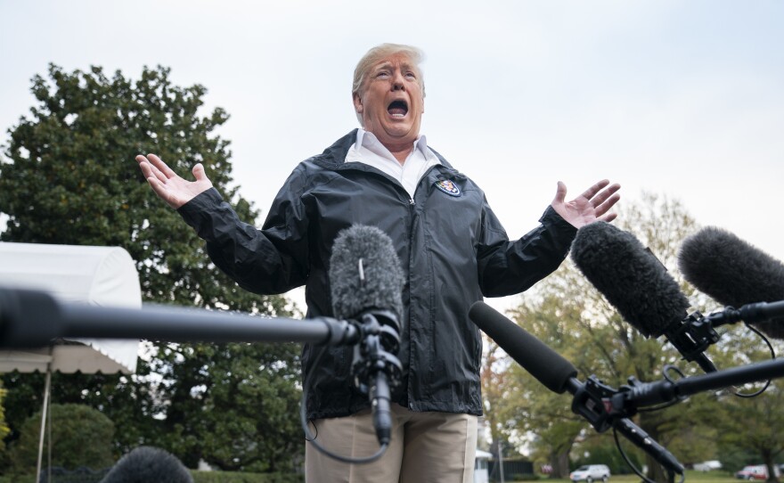 President Trump speaks to reporters before departing the White House for California in November.