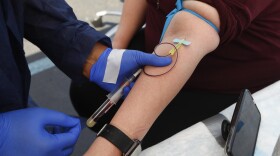 In this Friday, June 12, 2020 file photo, a woman has blood drawn for COVID-19 antibody testing in Dearborn, Mich.
