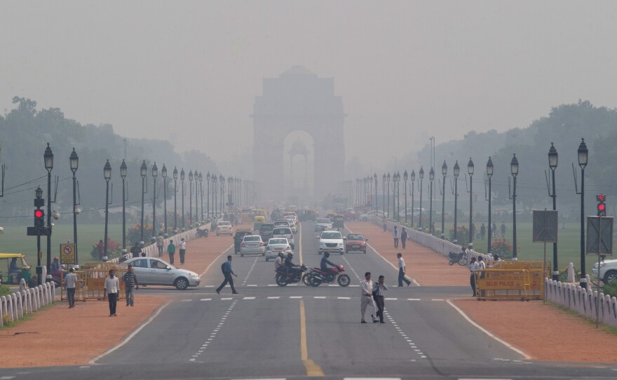 India Gate, a central Delhi landmark, is barely visible through thick smog in early November. The city's air quality has hit new lows recently.