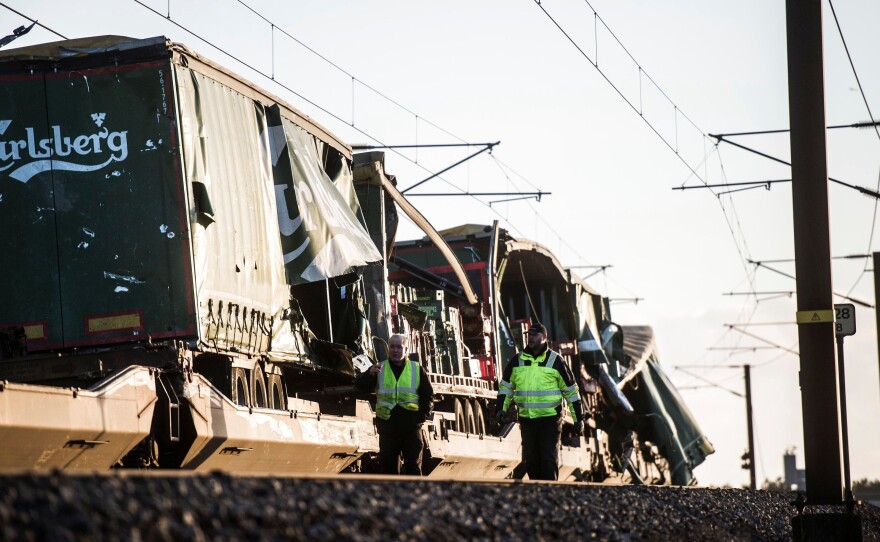 Investigators believe part of a freight train caused a fatal passenger train accident in Denmark on Wednesday. Here, the freight train is seen at the scene of the calamity on the Great Belt Bridge.