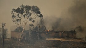 A mountain top home in the San Marcos area burns in the Cocos fire, May 15, 2014.
