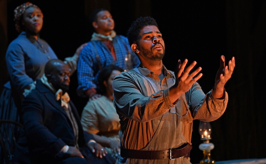 Congregants in one scene in <em>Castor and Patience</em> gather at a Watch Night service to await the hour when the Emancipation Proclamation is to take effect on Jan. 1, 1863. Foreground: Phillip Bullock. Clockwise, from top left: Zoie Reams, Victor Ryan Robertson, Amber Monroe, Earl Hazell.