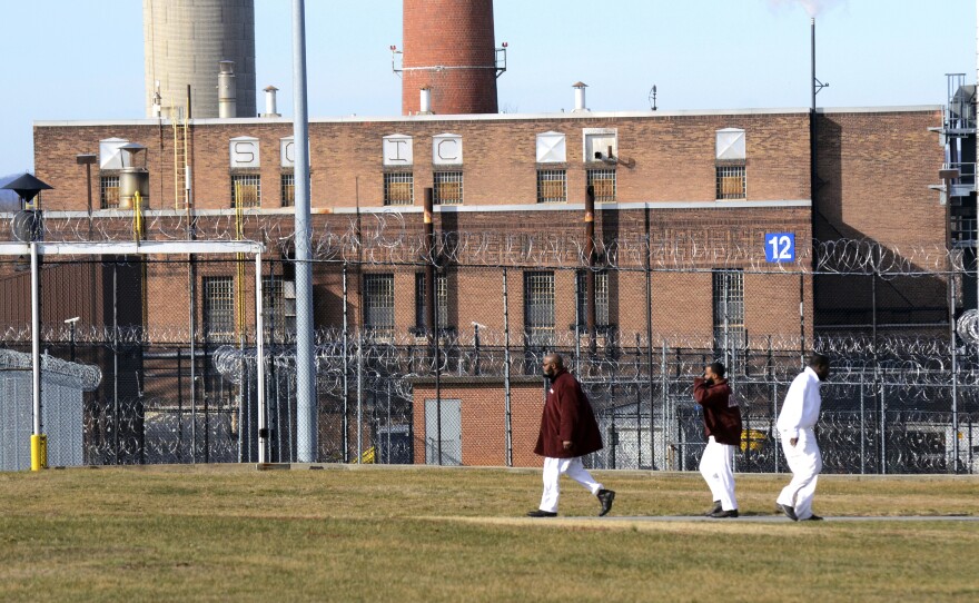 Incarcerated people walk across a yard at the State Correctional Institution at Camp Hill, Pa., in 2017. Maine and Vermont are the only states that allow incarcerated people to vote from prison.