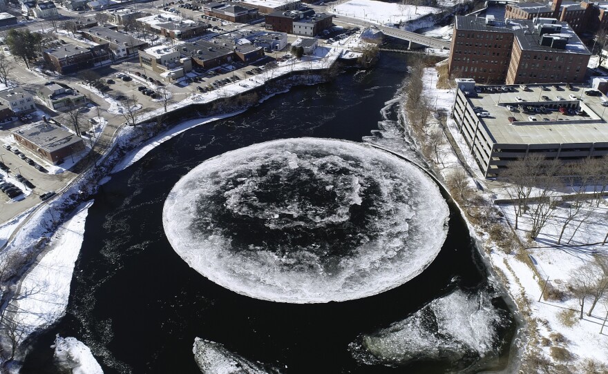 The ice disk is seen spinning on the Presumpscot River in drone video image provided by the city of Westbrook, Maine.