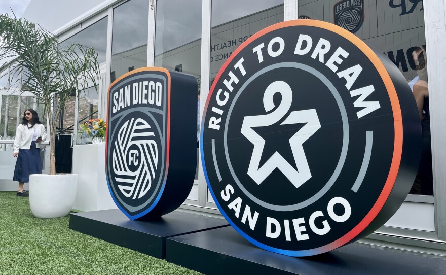Large logos of San Diego FC and Right to Dream Academy stand outside a tented hall at the team's El Cajon campus, Sept. 26, 2025.