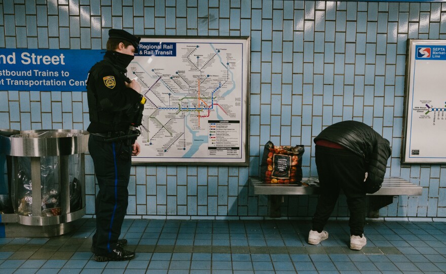 Bires checks in with a homeless man about needing outreach services. A study is looking into whether it's worth it to have police officers team up to offer social services or whether that task should be left to social workers alone.