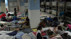 Homeless mothers and their children lay on blanket-covered mattresses at the San Diego Rescue Mission's Emergency Shelter, April 2013.