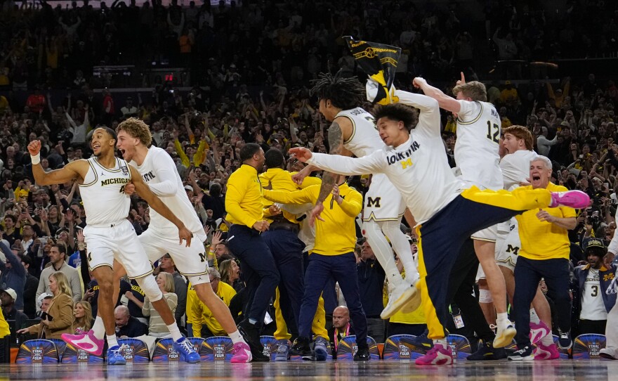 Members of Michigan celebrate after defeating UConn in the NCAA college basketball tournament national championship game at the Final Four, Monday, April 6, 2026, in Indianapolis.