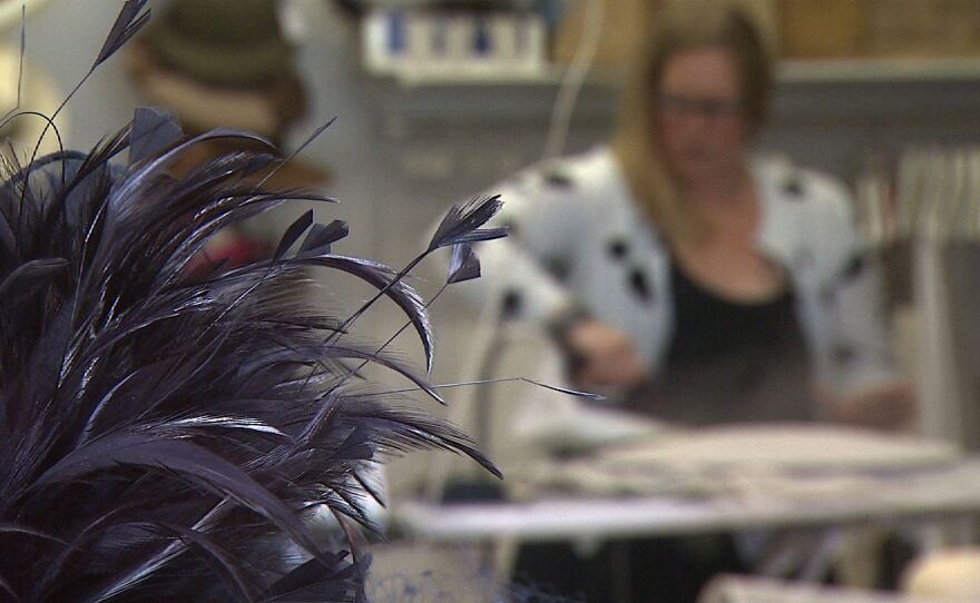 Jill Courtemanche uses steam to manipulate straw into hat shapes, June 25, 2015.