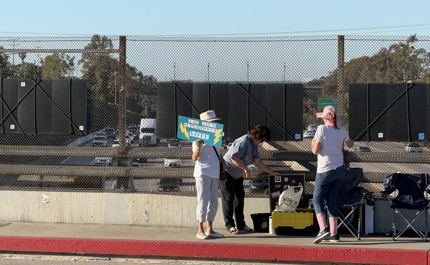 Susan and other Visibility Brigade attendees talk on the Meade Avenue bridge over I-805 on Oct. 8, 2026.