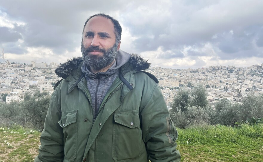 Issa Amro stands outside his home in Hebron. Amro says that since Oct. 7, settlers in and out of uniform have been harassing Palestinian civilians.