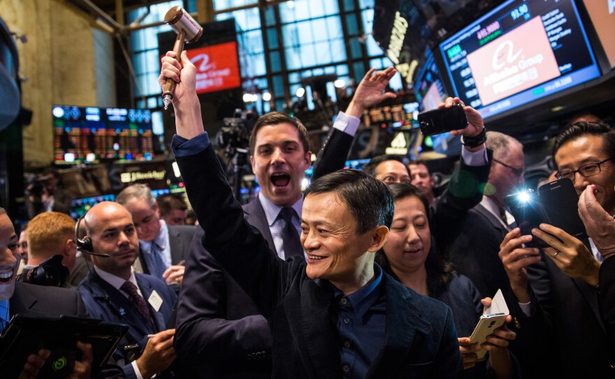 Founder and Executive Chairman of Alibaba Group Jack Ma celebrates as the Alibaba stock goes live on Friday.