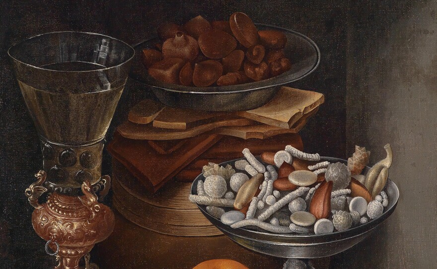 Still life with a bowl of candies and comfits, likely done in the 17th century. The landed gentry and even well-fed merchants could show off their wealth with a banquet of conserves and comfits – a candy made of a nut or seed coated in sugar. In The Merry Wives Of Windsor, Falstaff calls for "kissing comfits" to fall from the sky.