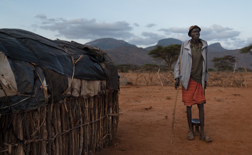 Paris's father, Loituku Lekuuk, stands outside his home. At first he didn't think he could afford to send Paris to school. But he was able to get money from a government official to cover the cost of at least some of the supplies — including $7 for the school uniform.