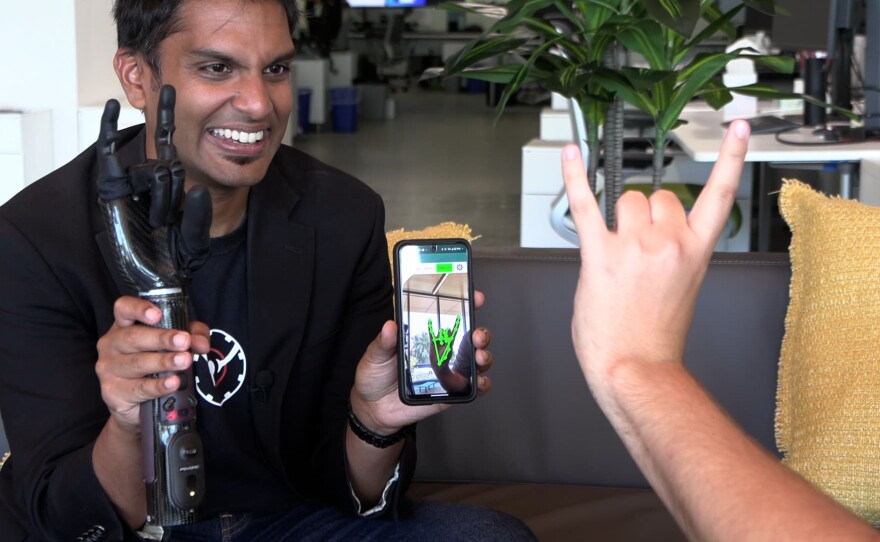 PSYONIC CEO and founder Aadeel Akhtar hold the Ability Hand while someone controls the prosthetic using the phone's camera, July 22, 2024.