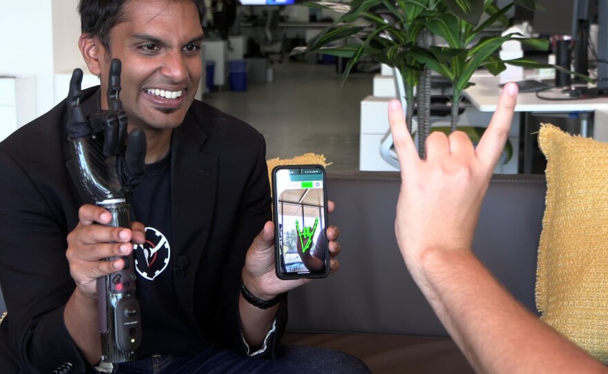 PSYONIC CEO and founder Aadeel Akhtar hold the Ability Hand while someone controls the prosthetic using the phone's camera, July 22, 2024. 