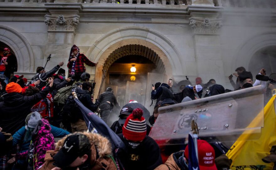 Pro-Trump rioters clash with police and security forces as people try to storm the U.S. Capitol on Jan. 6. Federal investigators say they expect even more people will be charged in connection with the insurrection.