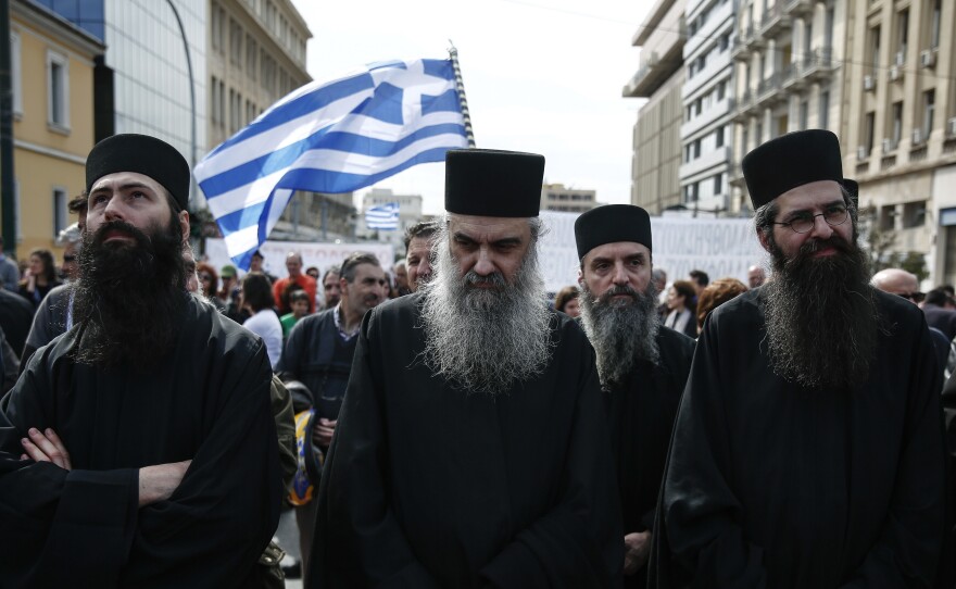 Greek Orthodox priests, seen during a rally in Athens earlier this year. On Tuesday Greek Orthodox Archbishop Ieronymos agreed with the prime minister to remove roughly 10,000 priests and staff from the state payroll.