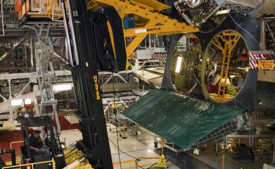 An engine is removed from space shuttle Endeavour after its final mission. Lookalike engines will replace the real ones when the shuttles go on display.