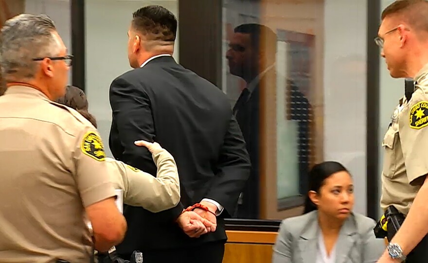 San Diego County Sheriff's Deputy Richard Fischer is escorted in handcuffs from his arraignment at the San Diego Superior Court in Vista, Feb. 22, 2018.