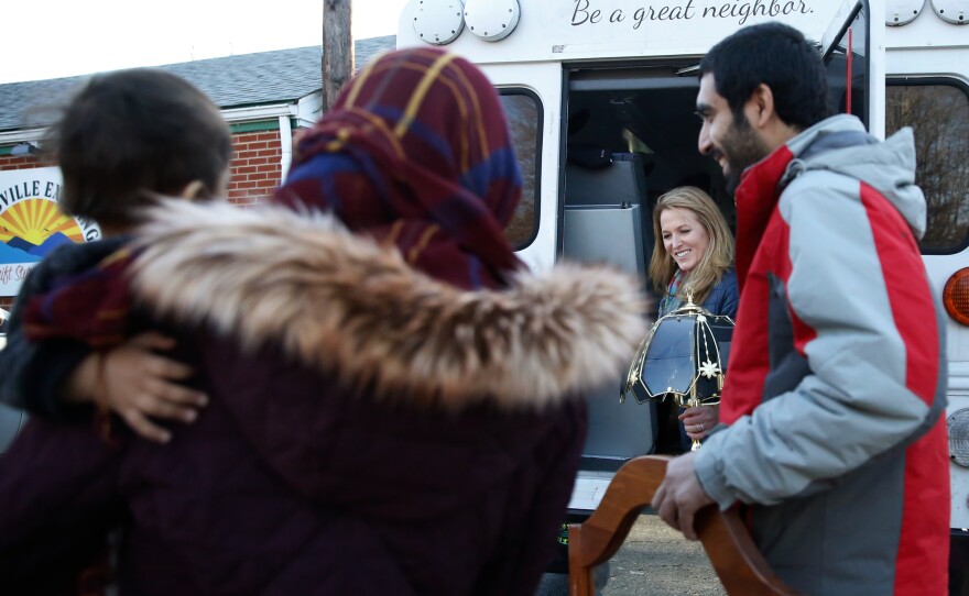 Kari Miller, the founder of International Neighbors, helps the Zaki family, who resettled from Afghanistan, load up the donated items they received from the Earlysville Exchange. The exchange is a thrift store just north of Charlottesville.