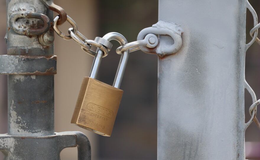 A padlock secures a fence at a school in Santee on Wednesday, Aug. 5, 2026.