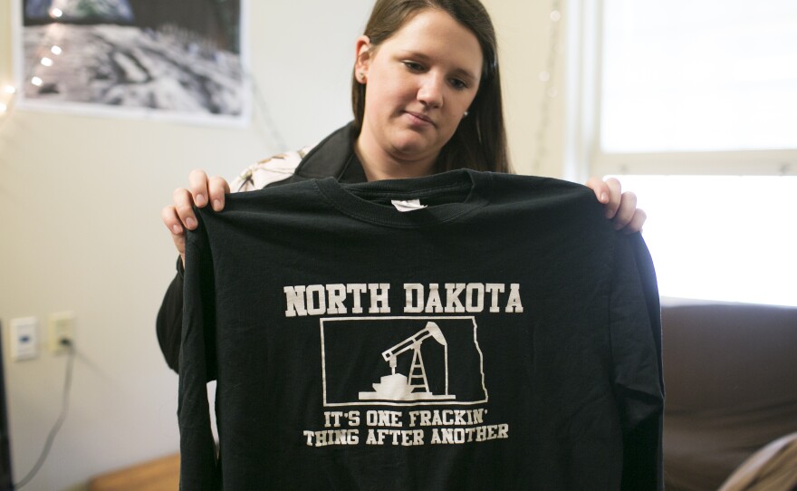 Taylor Debee, a senior petroleum engineering major at Marietta College, holds a shirt from her internship. Debee interned at Murex Petroleum Corporations in North Dakota.