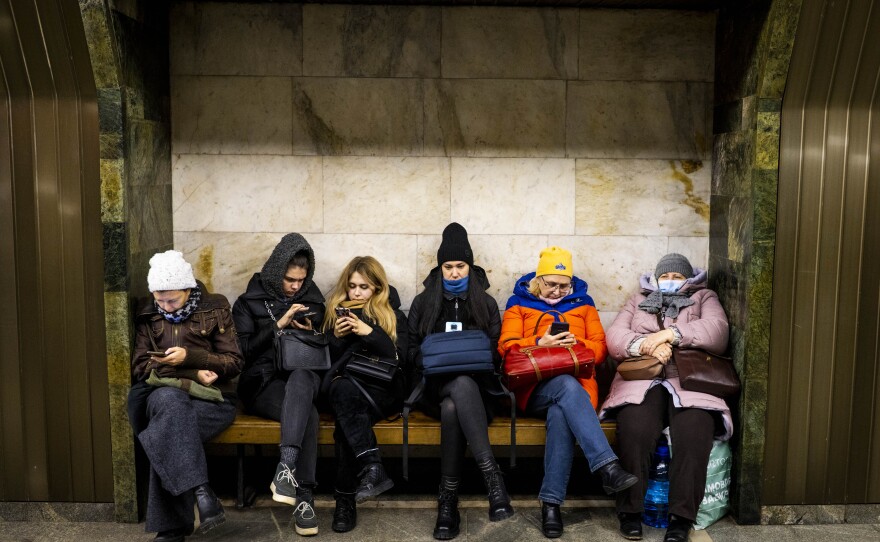 Civilians take shelter in Palats Sportu Metro during an air alert in Kyiv on Monday.