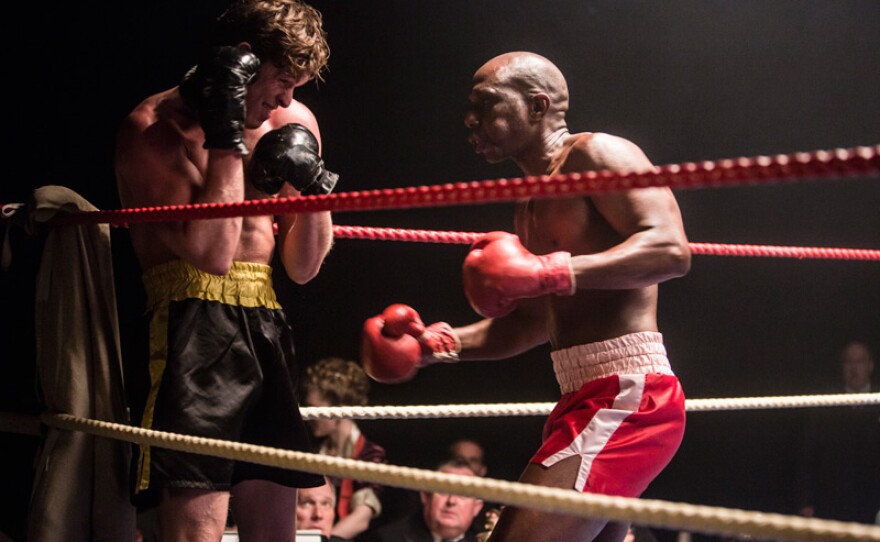 Jeb Cornish (CHRIS GORDON) in the boxing ring with Devon Hoyle (MENS SANA TAMAKLOE) in a scene from "The Chedworth Cyclone."