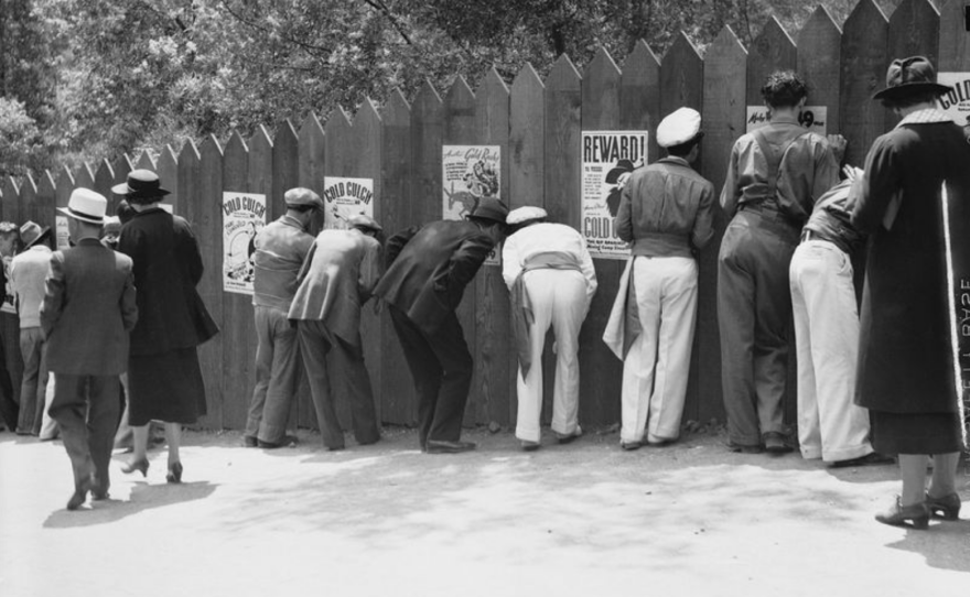 Spectators peek through holes in the fence surrounding nudists at Zoro Garden, 1935
