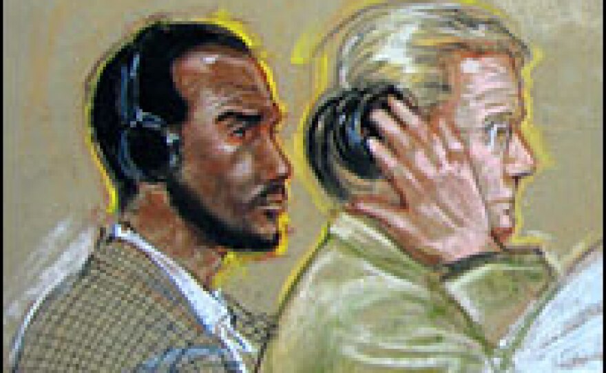 Salim Ahmed Hamdan is seated with his legal team inside the courtroom at Guantanamo Bay, Cuba, during a U.S. military tribunal arraignment on June 4, 2007.