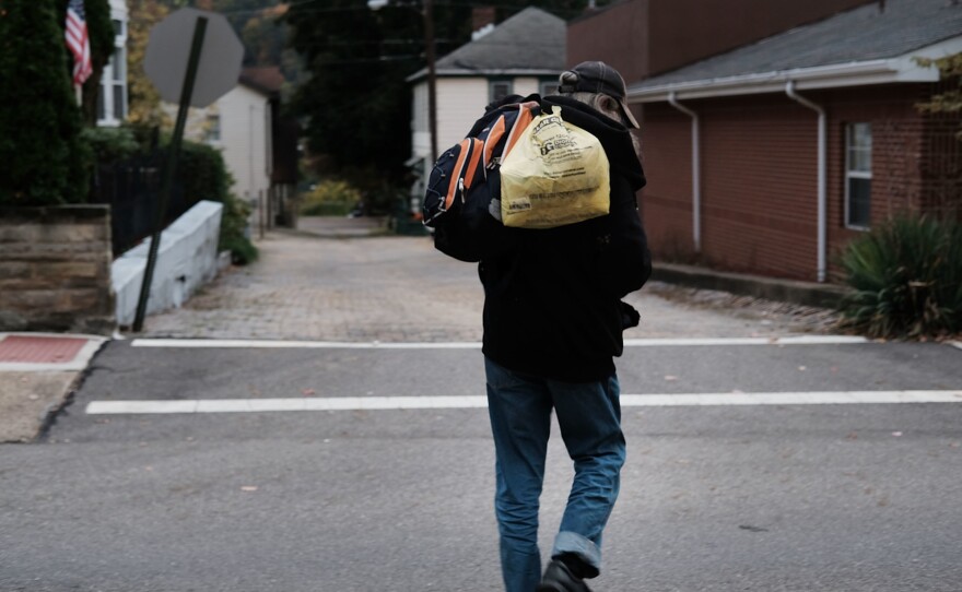 A homeless man walks downtown in East Liverpool, Ohio. Efforts to register homeless voters in the state have relied on churches and shelters volunteering to receive mail-in ballots for people with no permanent address.