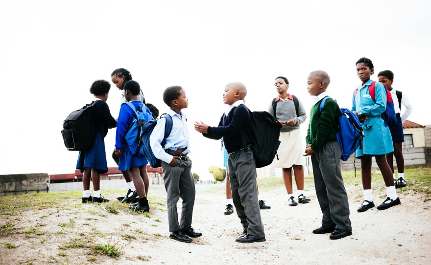 Kids in Cape Town socialize as they walk to school. Children in South Africa often don't get to play outside by themselves because of the high rate of violent crimes in some areas.