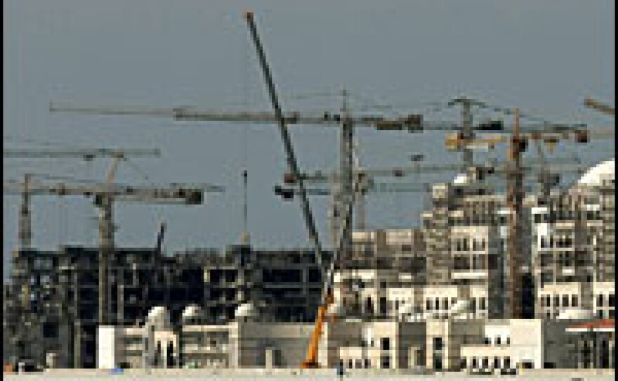 Tower cranes on Palm Island in Dubai.  Market fallout has led to a slump in the construction sector, which has the potential to cost many laborers their jobs.