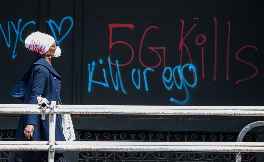 A pedestrian walks past anti-5G graffiti in the Flatiron District of New York in May.