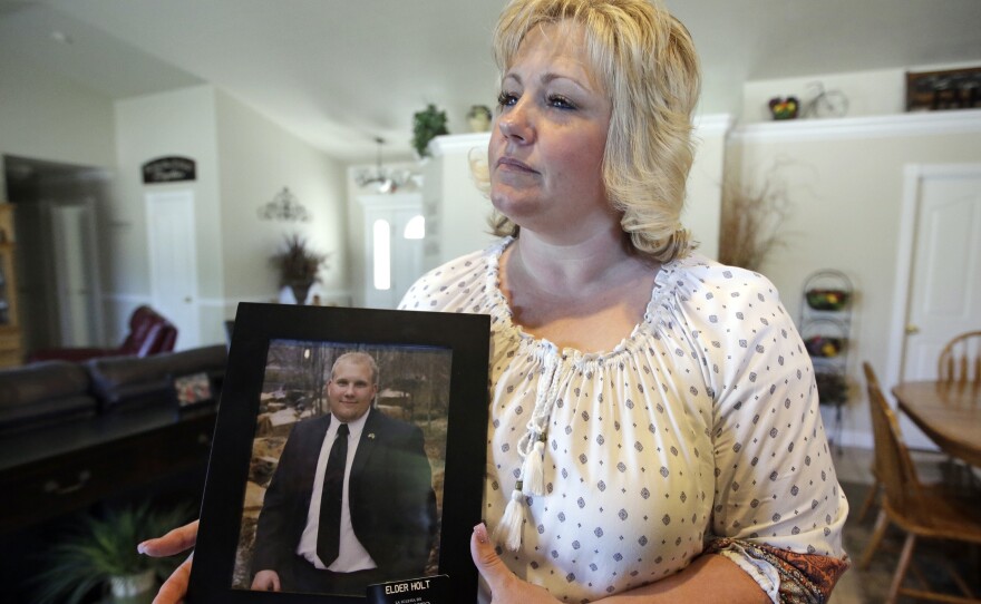 Laurie Holt holds a photograph of her son Joshua Holt, who has been jailed in Venezuela, at her home in Riverton, Utah, in July 2016. "Eventually," she says, "he'll come home and we'll be able to go back to our normal lives. And I can stop crying every night."