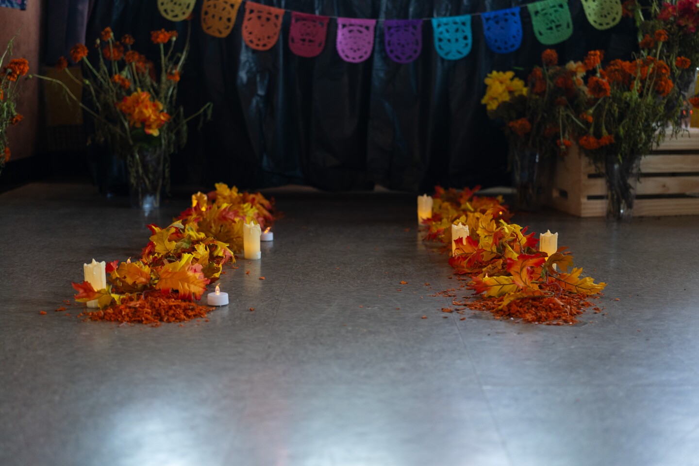 Marigold flower petals, fall leaves and tea light candles form a pathway toward an altar at the Sherman Heights Community Center in San Diego on Oct. 17, 2023.