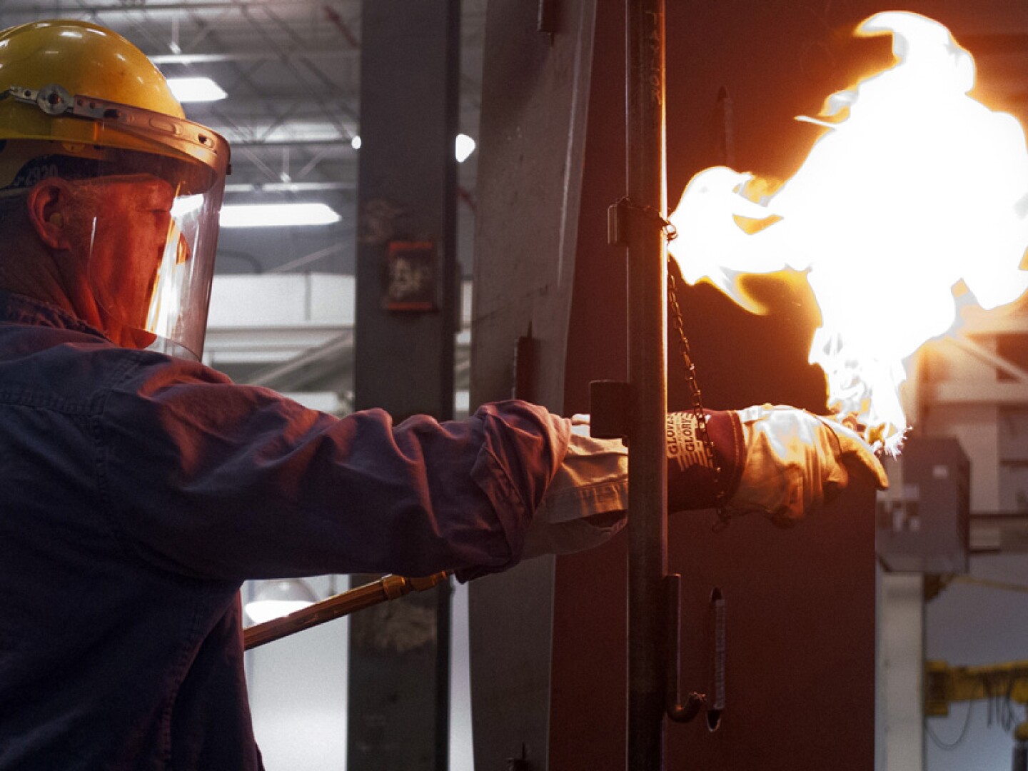 Albert Paley lights a torch.