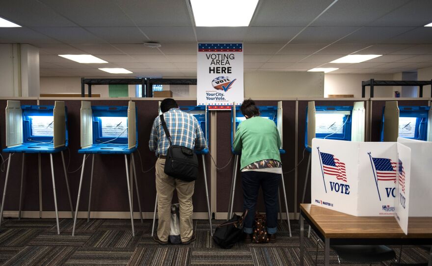 Joseph and Maria Caruso vote inside the Early Vote Center in downtown Minneapolis on Oct. 5, 2016. The Supreme Court on Thursday struck down a Minnesota law that prohibited voters from wearing politically themed items inside polling places.