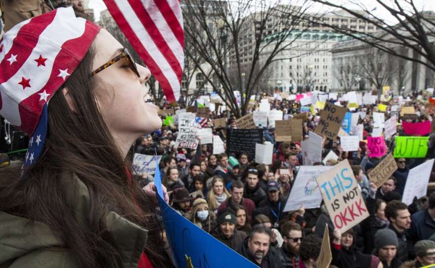 Demonstrators gather near the White House to protest President Trump's temporary immigration freeze on Sunday.