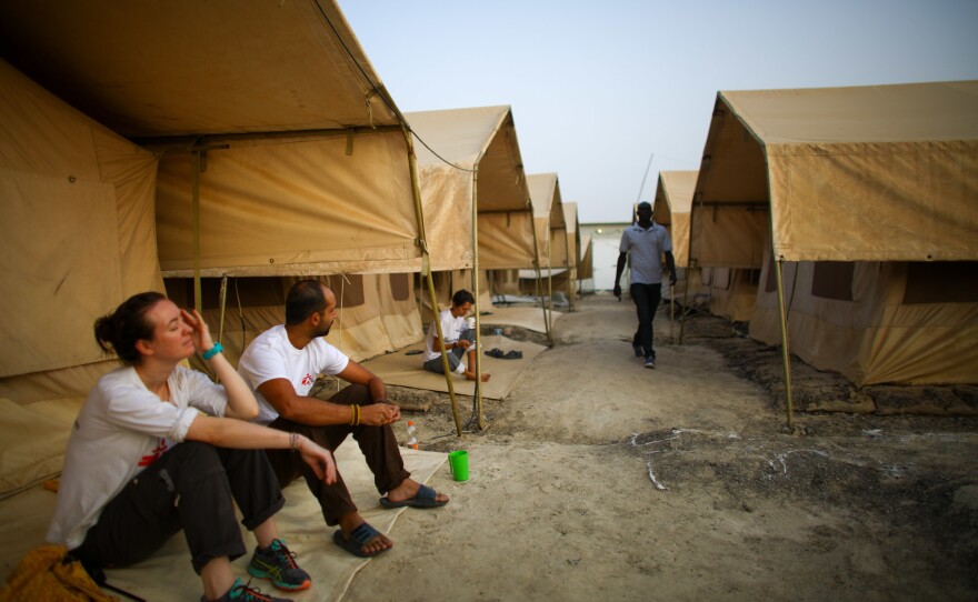 Morning at the MSF hospital compound in Bentiu, South Sudan. The two doctors, Jiske Steemsna (left) and Navpreet Sahsi, sit in front of the tents that serve as living quarters for the international workers during their three-to-six-month stints.