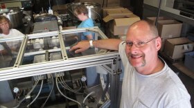 Stephen Mullany, who runs The Wiffle Ball Inc. with his brother David, poses in front of the machine that presses the two plastic ball halves together at a factory in Shelton, Conn. Mullany's grandfather invented the Wiffle Ball in the 1950s.